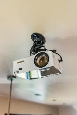 a camera hanging from the ceiling of a room at Luxury private farmhouse cottage near Amsterdam plus home cinema in Ilpendam