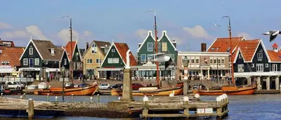 a group of boats docked in a harbor with buildings at Luxury private farmhouse cottage near Amsterdam plus home cinema in Ilpendam