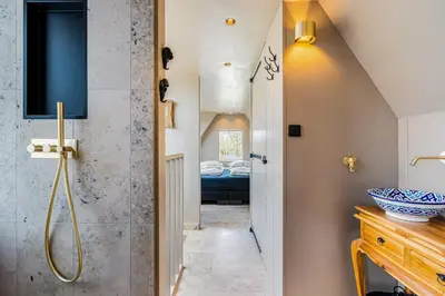 a bathroom with a walk in shower and a sink at Luxury private farmhouse cottage near Amsterdam plus home cinema in Ilpendam