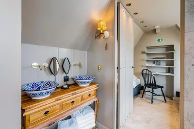 a bathroom with two bowls on a wooden dresser at Luxury private farmhouse cottage near Amsterdam plus home cinema in Ilpendam