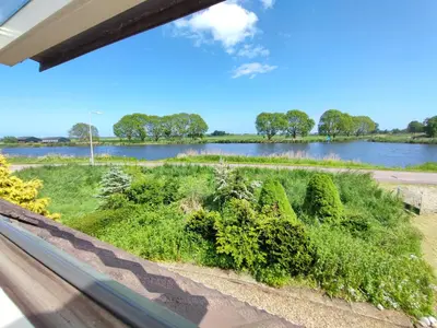 a view of a river from a window at Guesthouse at the Amstel river with 2BR 2BA and garden in Amstelveen