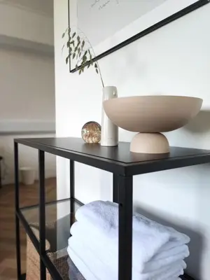 a black console table with a bowl on top at Guesthouse at the Amstel river with 2BR 2BA and garden in Amstelveen