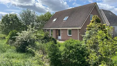 a brick house with a gambrel roof at Guesthouse at the Amstel river with 2BR 2BA and garden in Amstelveen
