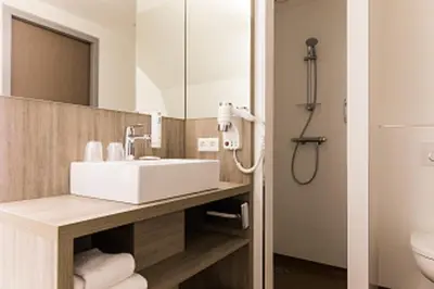 a bathroom with a sink and a shower at Best Western City Hotel Woerden in Woerden