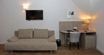 a living room with a couch and a desk at Best Western City Hotel Woerden in Woerden