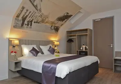 a bedroom with a large bed in a room at Best Western City Hotel Woerden in Woerden