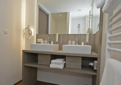 a bathroom with two sinks and a large mirror at Best Western City Hotel Woerden in Woerden