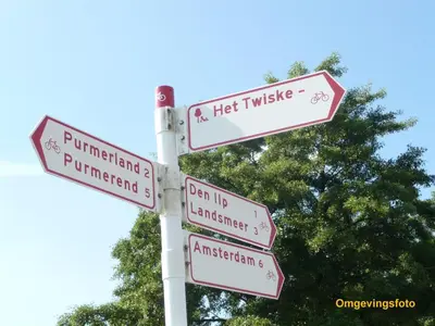 a pole with street signs in front of a tree at Amsterdam Countryside met Airco ,Geweldig uitzicht, luxe keuken,wasmachine,droger,gratis fietsen in Den Ilp