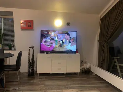 a living room with a flat screen tv at Amsterdam Countryside met Airco ,Geweldig uitzicht, luxe keuken,wasmachine,droger,gratis fietsen in Den Ilp
