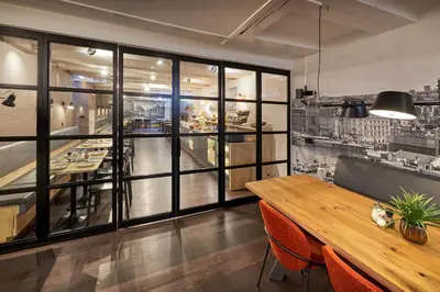 a dining room with a table and some windows at Nova Hotel in Amsterdam