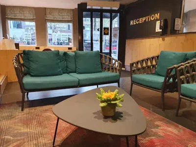 a waiting room with a couch and a table at Nova Hotel in Amsterdam