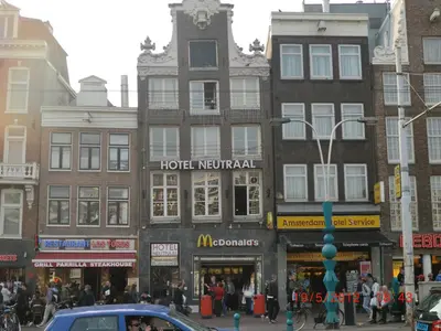 a group of buildings on a busy city street at Budget Hotel Neutraal in Amsterdam
