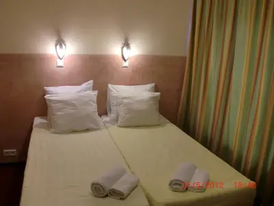 a hotel room with a bed with towels on it at Budget Hotel Neutraal in Amsterdam