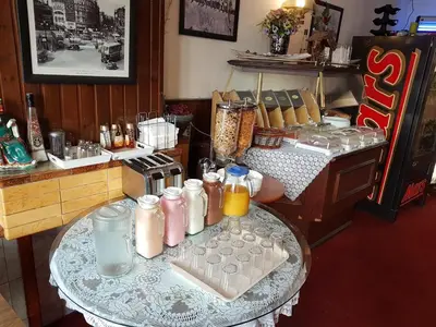 a kitchen with a table with some drinks on it at Budget Hotel Neutraal in Amsterdam