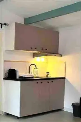 a kitchen with a sink and a counter top at Cozy comfortable house with jacuzzi & private garden near Amsterdam in Vijfhuizen