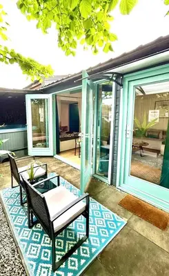 a patio with chairs and a table on a house at Cozy comfortable house with jacuzzi & private garden near Amsterdam in Vijfhuizen