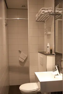 a bathroom with a toilet and a sink at Hotel Amsterdam De Roode Leeuw in Amsterdam