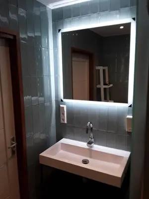 a bathroom with a sink and a mirror at vakantiehuis Warder in Warder
