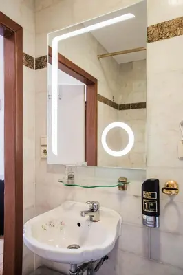 a bathroom with a sink and a mirror at Hotel Atlanta in Amsterdam