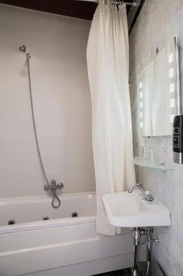 a bathroom with a sink and a tub and a shower at Hotel Atlanta in Amsterdam