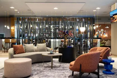 a lobby with a couch and a table and chairs at Bilderberg Garden Hotel in Amsterdam