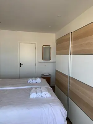 a bedroom with a bed with two towels on it at North Sea Spirit in Zandvoort