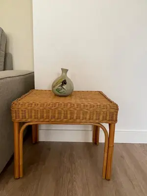 a wicker table with a vase sitting on top of it at North Sea Spirit in Zandvoort