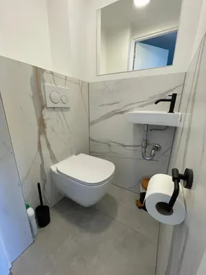 a bathroom with a white toilet and a mirror at North Sea Spirit in Zandvoort