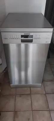 a stainless steel dishwasher sitting on a kitchen floor at Cappuccetto Rosso in Nieuwe-Niedorp
