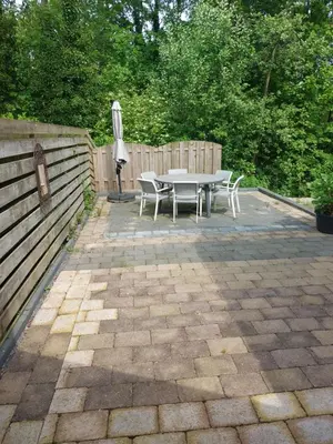 a patio with a table and an umbrella at Cappuccetto Rosso in Nieuwe-Niedorp