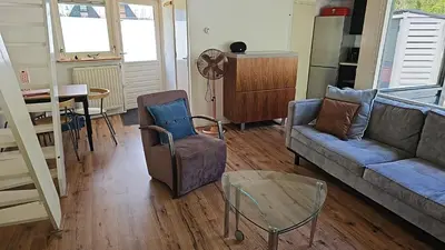 a living room with a couch and a table at Cappuccetto Rosso in Nieuwe-Niedorp