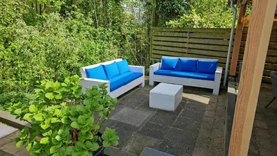 two blue chairs and a table on a patio at Cappuccetto Rosso in Nieuwe-Niedorp