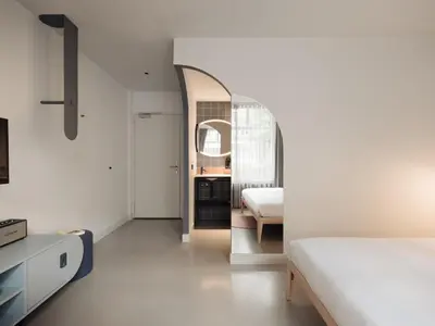 a bedroom with a bed and a mirror at Conscious Hotel Museum Square in Amsterdam