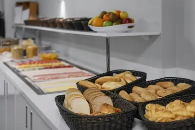 three baskets filled with bread and other foods on a counter at Hotel City Garden Amsterdam in Amsterdam