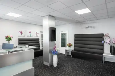 a waiting room with vases of flowers at Hotel City Garden Amsterdam in Amsterdam
