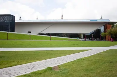 a bridge over a field of grass with a building at Budget Trianon Hotel in Amsterdam