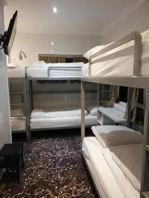a room with several bunk beds in it at Budget Trianon Hotel in Amsterdam