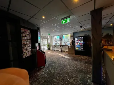 a gas station with an exit sign on the ceiling at Budget Trianon Hotel in Amsterdam