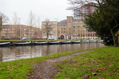 a group of boats docked in a river with buildings at PRIVATE APPARTMENT 60m2 - CENTRE TOP LOCATION in Amsterdam