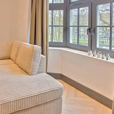 a living room with a couch and two windows at PRIVATE APPARTMENT 60m2 - CENTRE TOP LOCATION in Amsterdam
