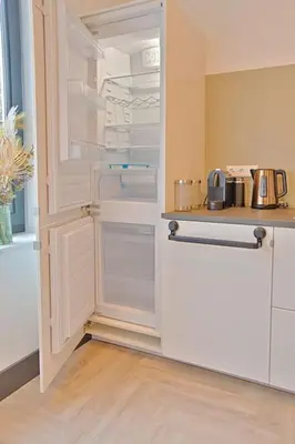 a kitchen with an empty refrigerator with its door open at PRIVATE APPARTMENT 60m2 - CENTRE TOP LOCATION in Amsterdam