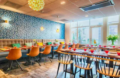 a restaurant with tables and chairs in a room at Leonardo Boutique Hotel Amsterdam Vondelpark in Amsterdam