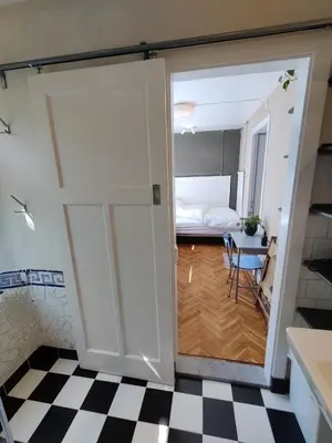 a room with a door leading to a bedroom at House of Straw Amsterdam in Amsterdam