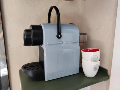 a coffee maker sitting on a shelf next to a cup at House of Straw Amsterdam in Amsterdam