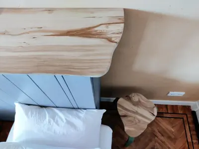 a bedroom with a bed with a wooden headboard at House of Straw Amsterdam in Amsterdam
