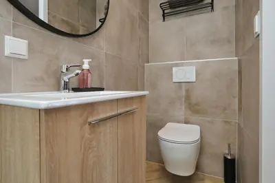 a bathroom with a sink and a toilet at appartement-gratis parkeren -bij strand en in het centrum in Noordwijk