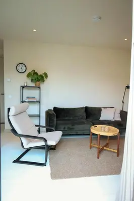 a living room with a couch and a table at Zilt aan Zee in Egmond aan Zee