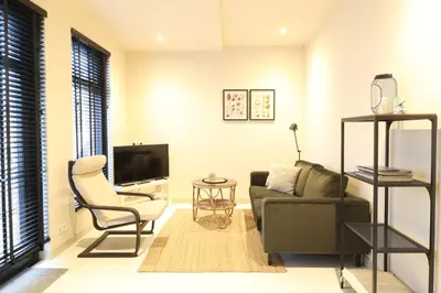a living room with a couch and a chair at Zilt aan Zee in Egmond aan Zee