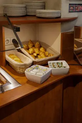 a counter with several bowls of food on it at A-Train Hotel in Amsterdam