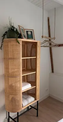 a book shelf with a plant on top of it at Have a nice stay! - Little Loft, Summerhouse near the beach in Noordwijk aan Zee